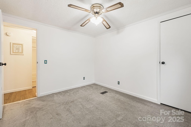 311 Flynn Br, Madison, NC 28753 - carpeted empty room featuring ceiling fan, ornamental molding, and a textured ceiling