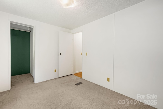 311 Flynn Br, Madison, NC 28753 - spare room with carpet flooring and a textured ceiling