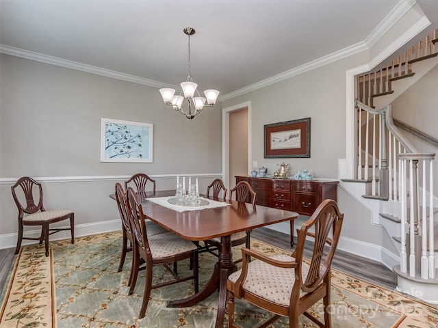 1011 Golden Bell Dr, Waxhaw, NC 28173 - dining area featuring wood finished floors, ornamental molding, stairway, and a chandelier