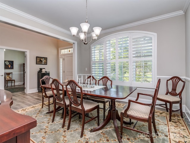 1011 Golden Bell Dr, Waxhaw, NC 28173 - dining space with ornamental molding, wood finished floors, a chandelier, and wainscoting