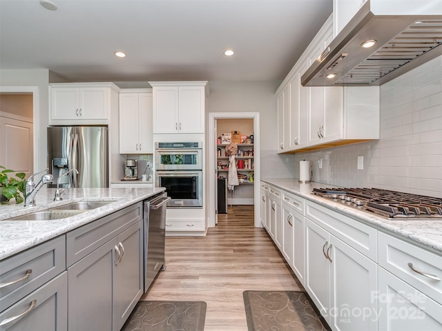 1011 Golden Bell Dr, Waxhaw, NC 28173 - kitchen featuring ventilation hood, stainless steel appliances, tasteful backsplash, white cabinets, and recessed lighting