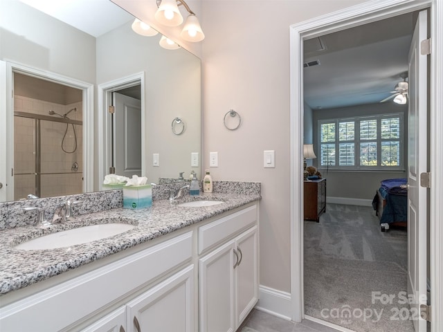 1011 Golden Bell Dr, Waxhaw, NC 28173 - full bathroom featuring connected bathroom, double vanity, a shower stall, and a ceiling fan