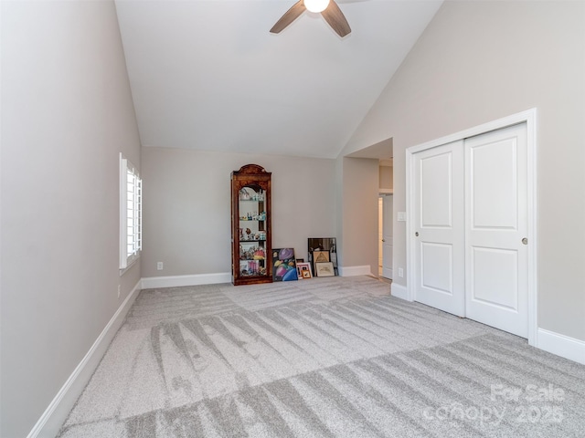 1011 Golden Bell Dr, Waxhaw, NC 28173 - unfurnished living room featuring a ceiling fan, high vaulted ceiling, and carpet floors