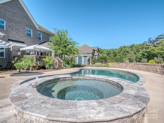 1011 Golden Bell Dr, Waxhaw, NC 28173 - view of pool featuring a wooden deck, a pool with connected hot tub, and a storage unit