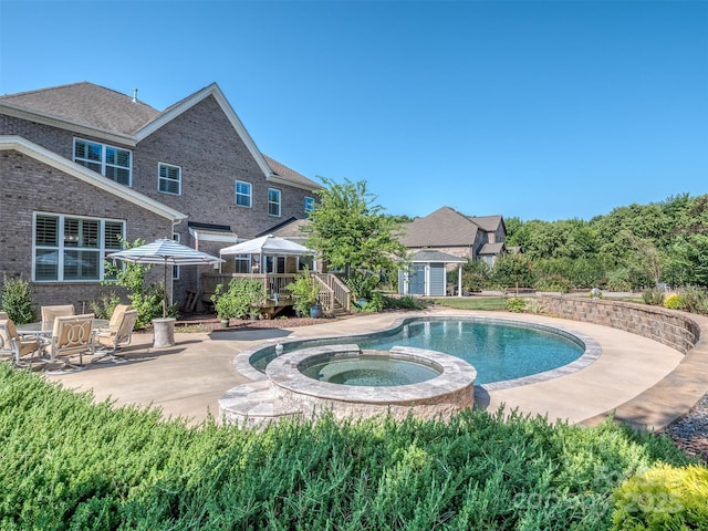 1011 Golden Bell Dr, Waxhaw, NC 28173 - view of pool featuring a deck, a pool with connected hot tub, a shed, and a patio