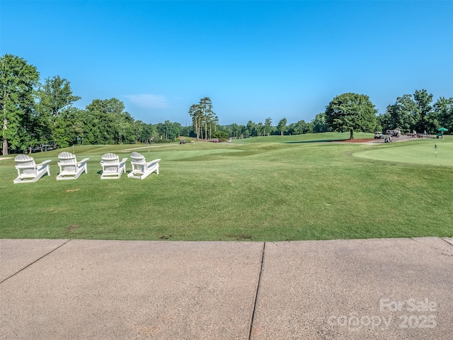 1011 Golden Bell Dr, Waxhaw, NC 28173 - surrounding community with a putting green, a lawn, golf course view, and view of wooded area