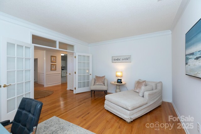 6507 Fairway Point Dr, Charlotte, NC 28269 - living area featuring ornamental molding, wood finished floors, french doors, and a textured ceiling