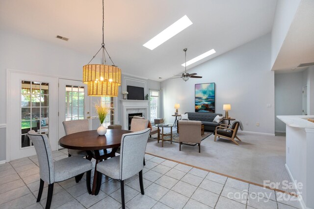 6507 Fairway Point Dr, Charlotte, NC 28269 - dining room with high vaulted ceiling, a skylight, a fireplace, light colored carpet, and a ceiling fan