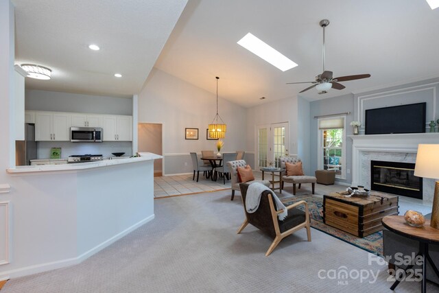 6507 Fairway Point Dr, Charlotte, NC 28269 - living area featuring a high end fireplace, light colored carpet, high vaulted ceiling, ceiling fan, and recessed lighting