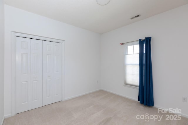 6507 Fairway Point Dr, Charlotte, NC 28269 - unfurnished bedroom featuring light carpet and a closet
