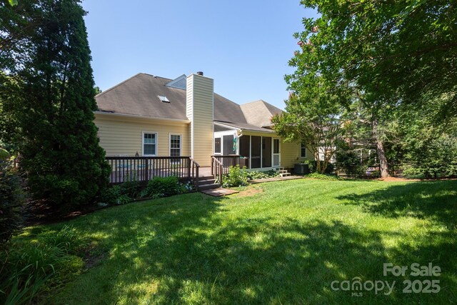 6507 Fairway Point Dr, Charlotte, NC 28269 - rear view of property with a chimney, a sunroom, a yard, and a wooden deck