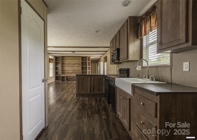 3655 Pinewood Rd, Sumter, SC 29154 - kitchen with a textured ceiling, electric range, a peninsula, dark wood-style floors, and dark countertops