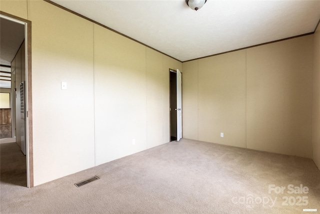 3655 Pinewood Rd, Sumter, SC 29154 - spare room with carpet floors, crown molding, and a decorative wall