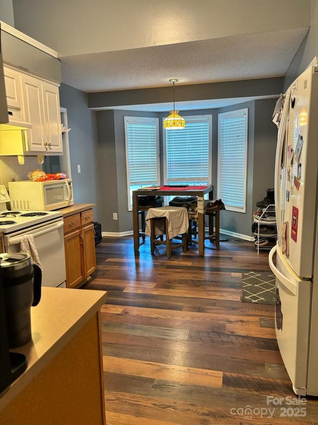 1920 Waldeck Ct, Mount Pleasant, NC 28124 - kitchen with white appliances, dark wood-style floors, tasteful backsplash, hanging light fixtures, and white cabinetry