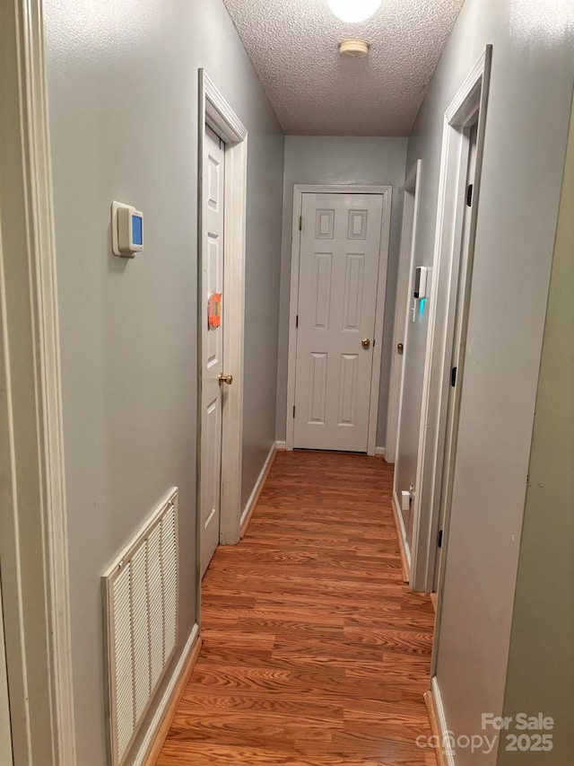 1920 Waldeck Ct, Mount Pleasant, NC 28124 - hall with light wood-type flooring and a textured ceiling