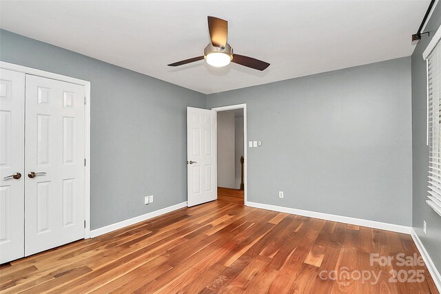 3730 Monique Ln, Charlotte, NC 28210 - unfurnished bedroom featuring wood finished floors, ceiling fan, and a closet