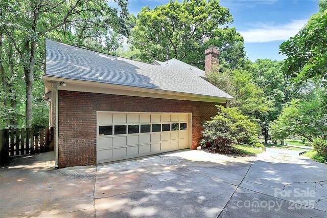 3730 Monique Ln, Charlotte, NC 28210 - view of side of property with driveway, roof with shingles, brick siding, and a chimney