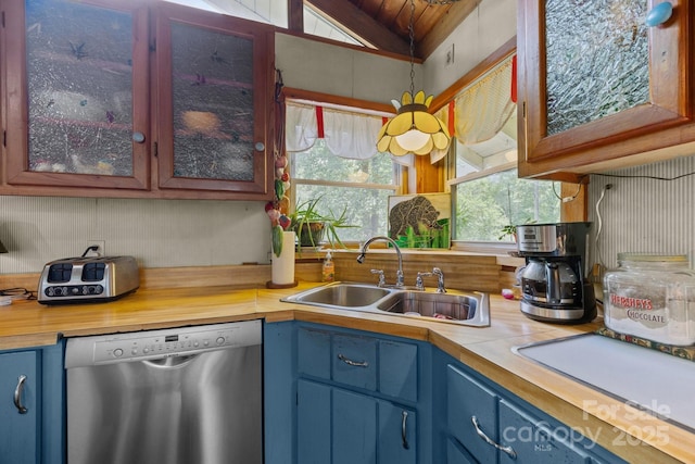 13884 Cruso Rd, Canton, NC 28716 - kitchen with stainless steel dishwasher, blue cabinets, glass insert cabinets, butcher block countertops, and vaulted ceiling