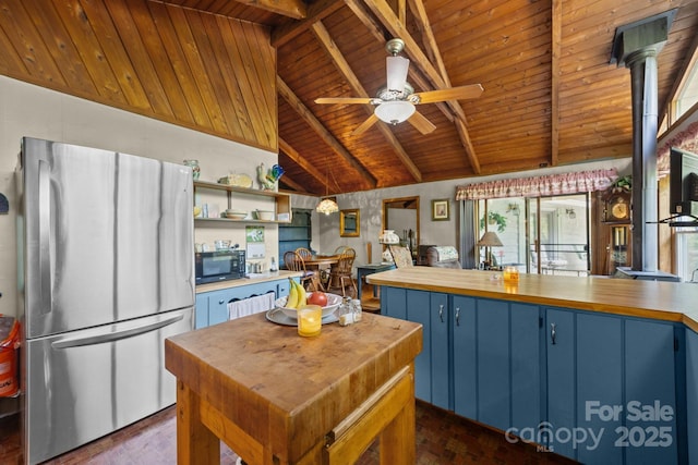 13884 Cruso Rd, Canton, NC 28716 - kitchen with freestanding refrigerator, blue cabinetry, wooden ceiling, black microwave, and ceiling fan