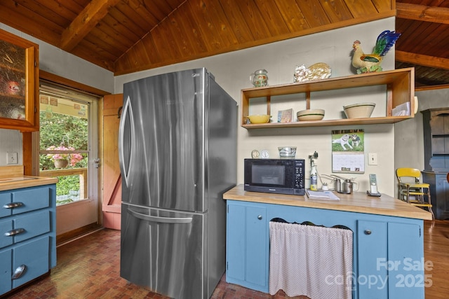 13884 Cruso Rd, Canton, NC 28716 - kitchen featuring freestanding refrigerator, blue cabinets, black microwave, wooden ceiling, and wooden counters