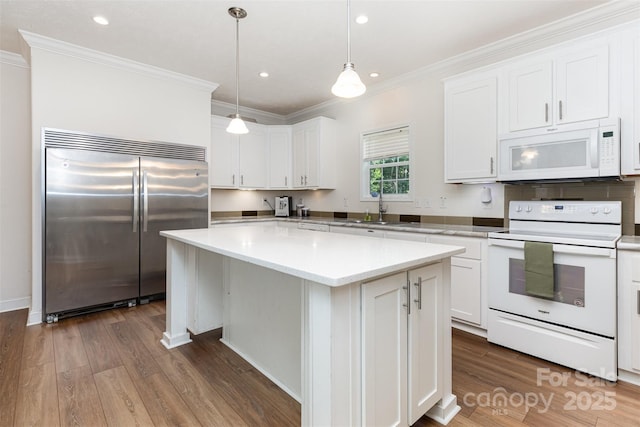 1593 Bloomfield Rd, Rock Hill, SC 29732 - kitchen with white appliances, dark wood finished floors, crown molding, white cabinetry, and a center island