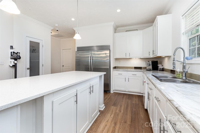 1593 Bloomfield Rd, Rock Hill, SC 29732 - kitchen featuring built in refrigerator, dark wood-type flooring, white cabinets, ornamental molding, and hanging light fixtures