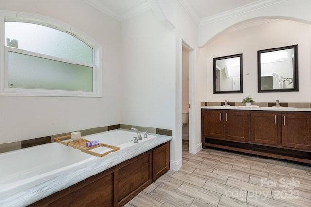 1593 Bloomfield Rd, Rock Hill, SC 29732 - bathroom featuring double vanity, a garden tub, wood finish floors, and crown molding