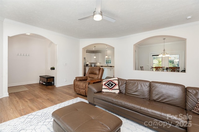 1593 Bloomfield Rd, Rock Hill, SC 29732 - living area featuring wood finished floors, arched walkways, ceiling fan, ornamental molding, and a chandelier