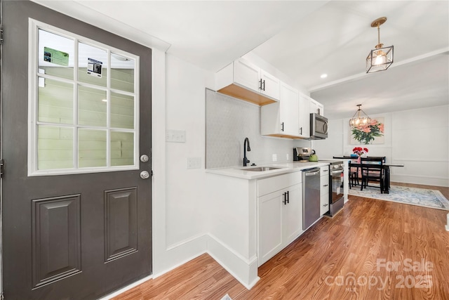 124 Marion St, Clover, SC 29710 - kitchen featuring stainless steel appliances, light wood finished floors, light countertops, and white cabinetry