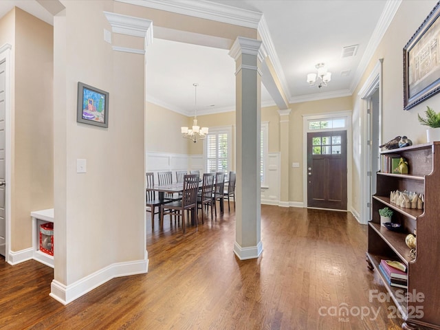612 Ideal Way, Charlotte, NC 28203 - foyer entrance with a chandelier, ornate columns, wood finished floors, and ornamental molding