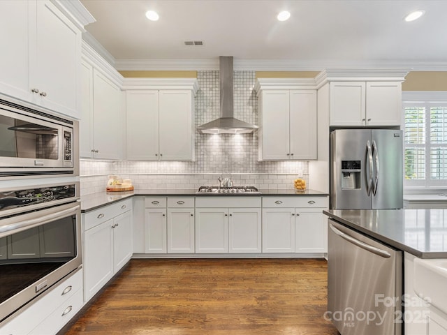 612 Ideal Way, Charlotte, NC 28203 - kitchen with appliances with stainless steel finishes, wall chimney exhaust hood, white cabinetry, ornamental molding, and decorative backsplash