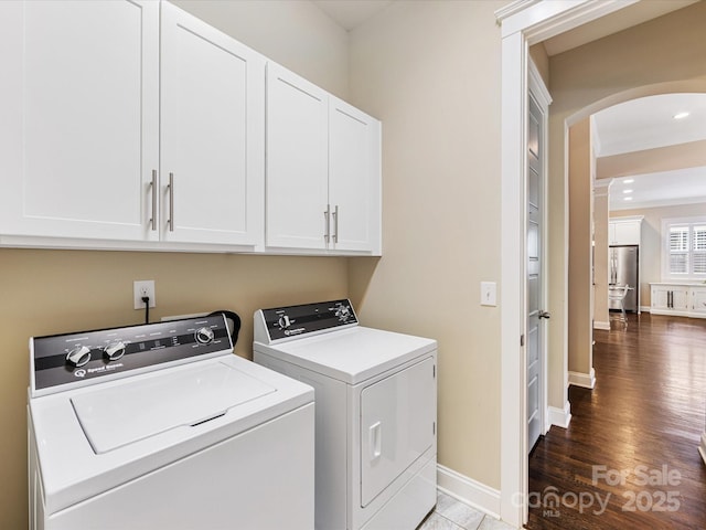 612 Ideal Way, Charlotte, NC 28203 - washroom with cabinet space, arched walkways, separate washer and dryer, and wood finished floors