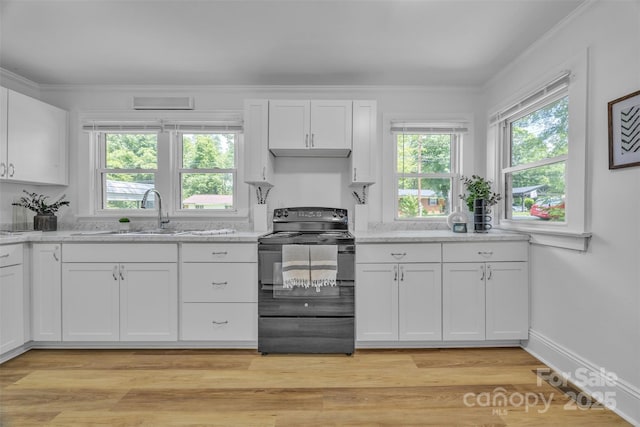 2222 19th Ave NE, Hickory, NC 28601 - kitchen featuring black range with electric stovetop, healthy amount of natural light, white cabinetry, light stone counters, and ornamental molding