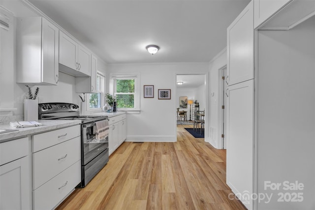 2222 19th Ave NE, Hickory, NC 28601 - kitchen with electric range, light countertops, light wood-style floors, white cabinetry, and crown molding