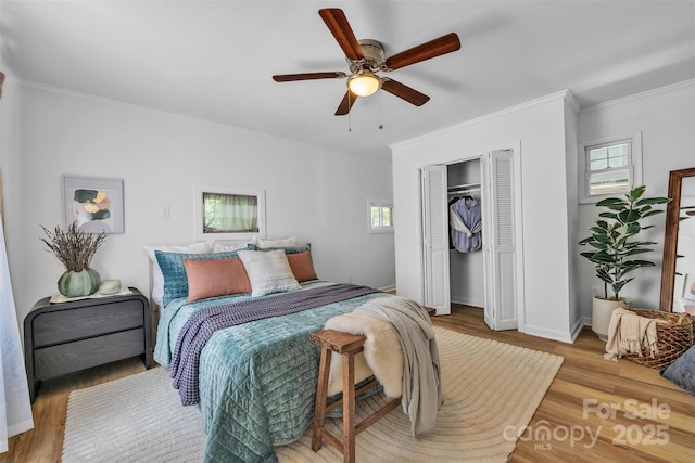 2222 19th Ave NE, Hickory, NC 28601 - bedroom featuring multiple windows, crown molding, wood finished floors, and a closet