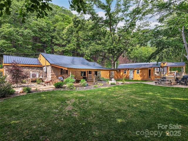 14715 Cruso Rd, Canton, NC 28716 - back of house with a lawn, stone siding, a metal roof, and a porch