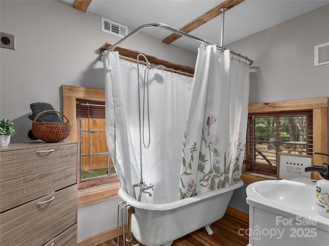 14715 Cruso Rd, Canton, NC 28716 - bathroom featuring wood finished floors, a freestanding tub, vanity, and a shower with shower curtain