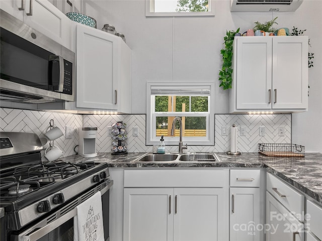 14715 Cruso Rd, Canton, NC 28716 - kitchen with stainless steel appliances, tasteful backsplash, dark countertops, and white cabinets