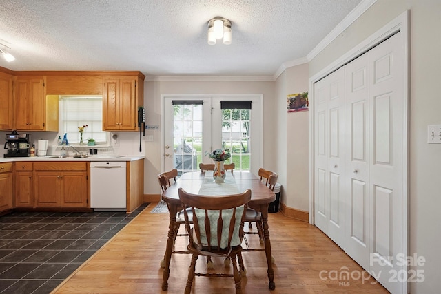 360 S Brady Ave, Newton, NC 28658 - kitchen featuring white dishwasher, light countertops, a textured ceiling, crown molding, and dark tile patterned floors