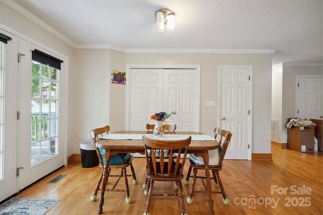 360 S Brady Ave, Newton, NC 28658 - dining space featuring light wood-style flooring, ornamental molding, and a textured ceiling