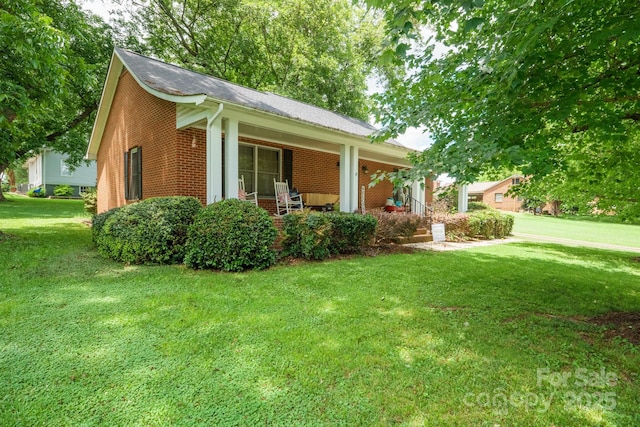 360 S Brady Ave, Newton, NC 28658 - view of front of home featuring brick siding, a porch, a front yard, and a shingled roof