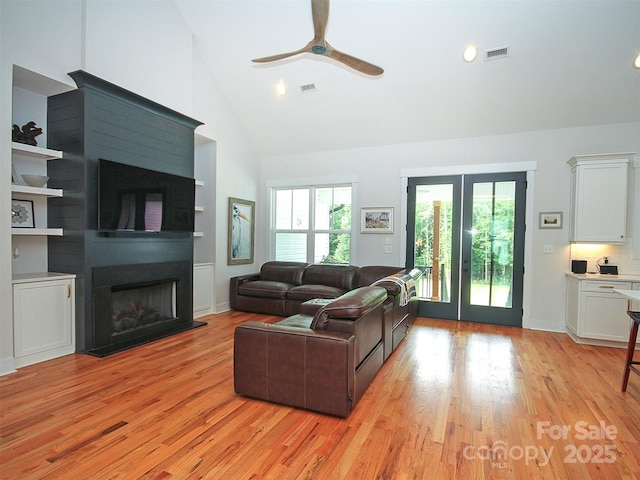 4282 Brandy Creek Ct, Clover, SC 29710 - living area featuring high vaulted ceiling, light wood-type flooring, a fireplace, ceiling fan, and healthy amount of natural light