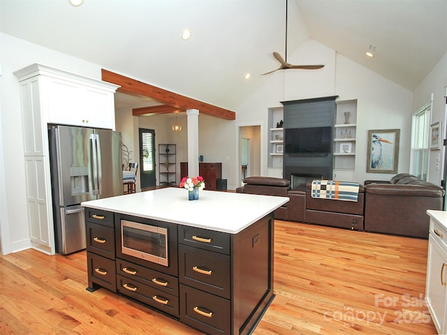 4282 Brandy Creek Ct, Clover, SC 29710 - kitchen with appliances with stainless steel finishes, white cabinetry, ornate columns, a ceiling fan, and light wood-style flooring
