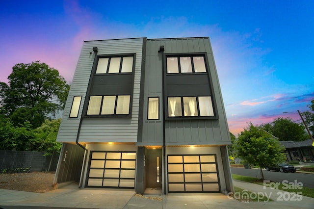 1933 W Trade St, Charlotte, NC 28216 - contemporary home with a garage, board and batten siding, and driveway