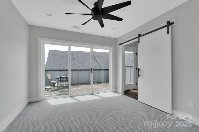 1933 W Trade St, Charlotte, NC 28216 - unfurnished room with carpet floors, a barn door, and a ceiling fan