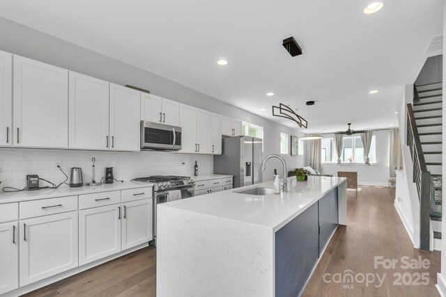 1933 W Trade St, Charlotte, NC 28216 - kitchen with stainless steel appliances, white cabinets, backsplash, light countertops, and recessed lighting