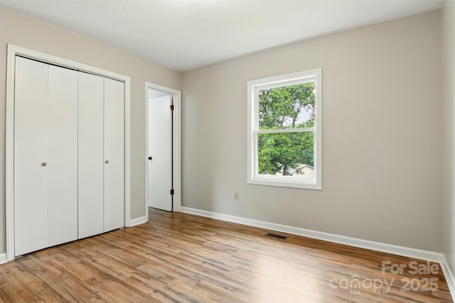 3404 Sheely Rd, Lenoir, NC 28645 - unfurnished bedroom with wood finished floors and a closet
