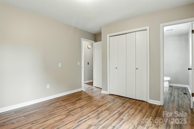 3404 Sheely Rd, Lenoir, NC 28645 - unfurnished bedroom with wood finished floors and a closet
