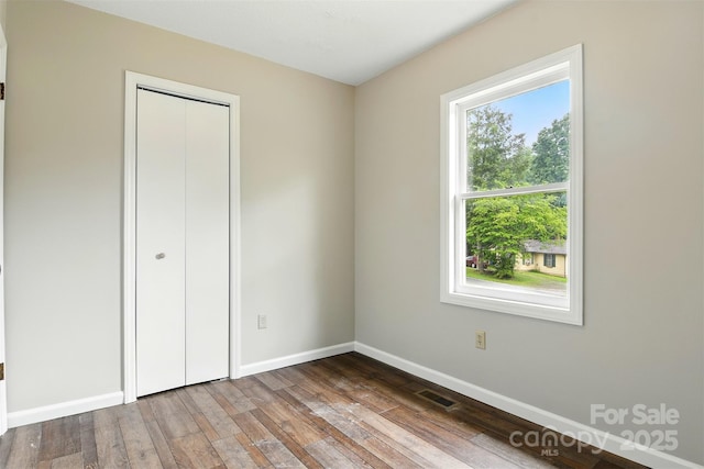 3404 Sheely Rd, Lenoir, NC 28645 - unfurnished bedroom with wood finished floors and a closet