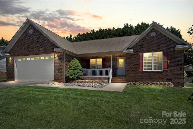 1011 Atherstone St NW, Conover, NC 28613 - view of front of home with covered porch, brick siding, a garage, concrete driveway, and a yard